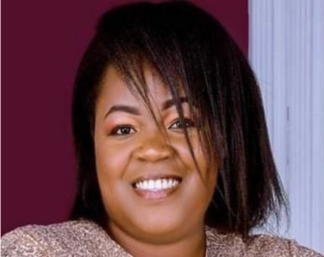 Woman with shoulder-length hair smiles at camera.